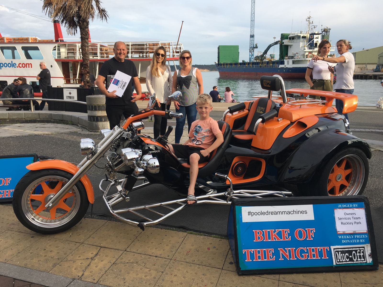 Winning motorbike pictured on Poole Quay with people around it.